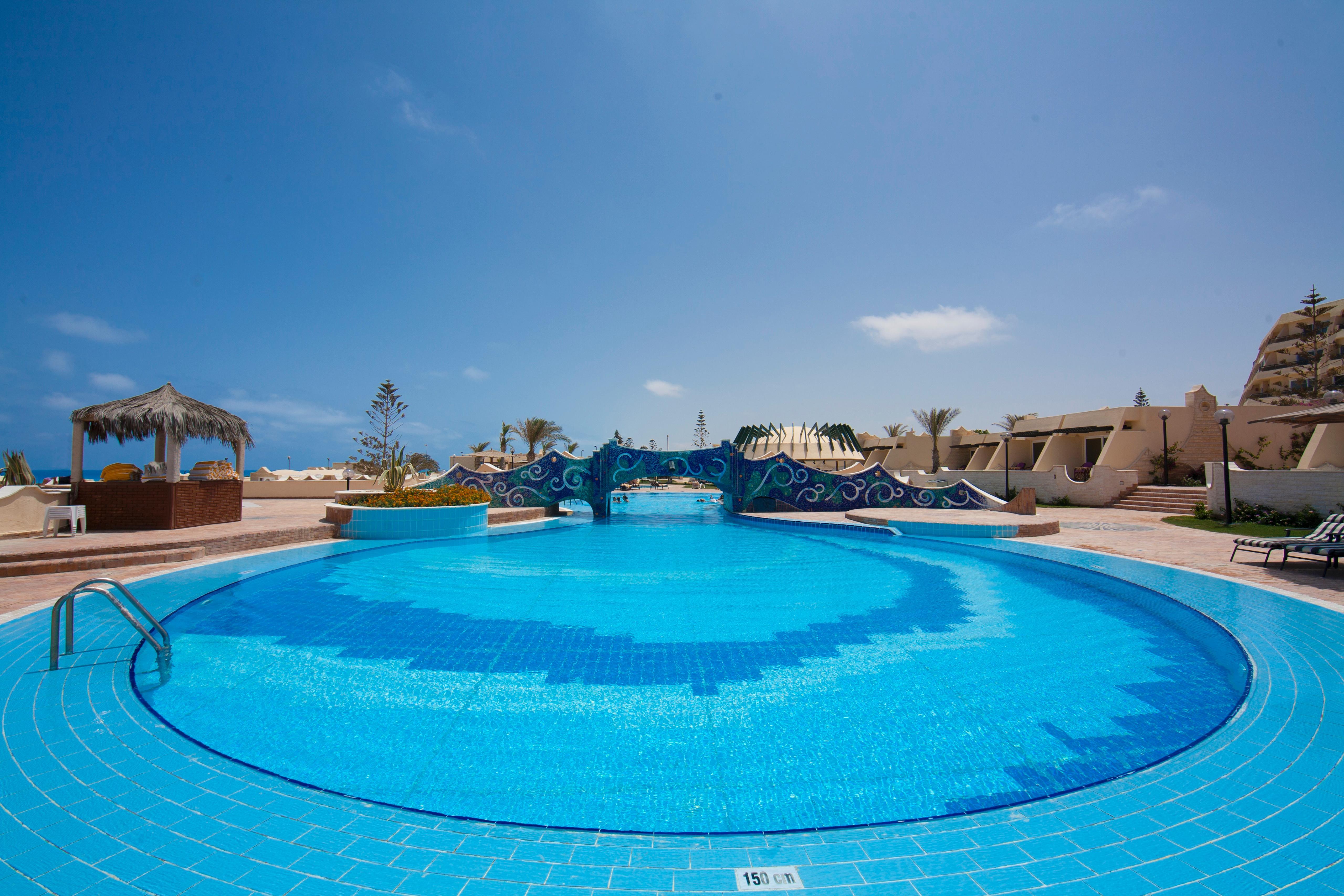 Borg El Arab Beach Resort Kültér fotó A swimming pool at a resort in Egypt